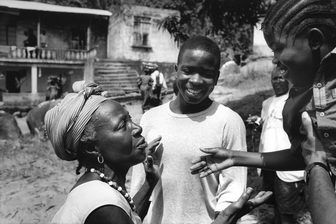 Rebecca Fillie, right, then aged 10, and Komba Kanessie, then aged 14 (both also appear in the first photograph in this series) being reunified with family in 2002, following several years of separation during the war