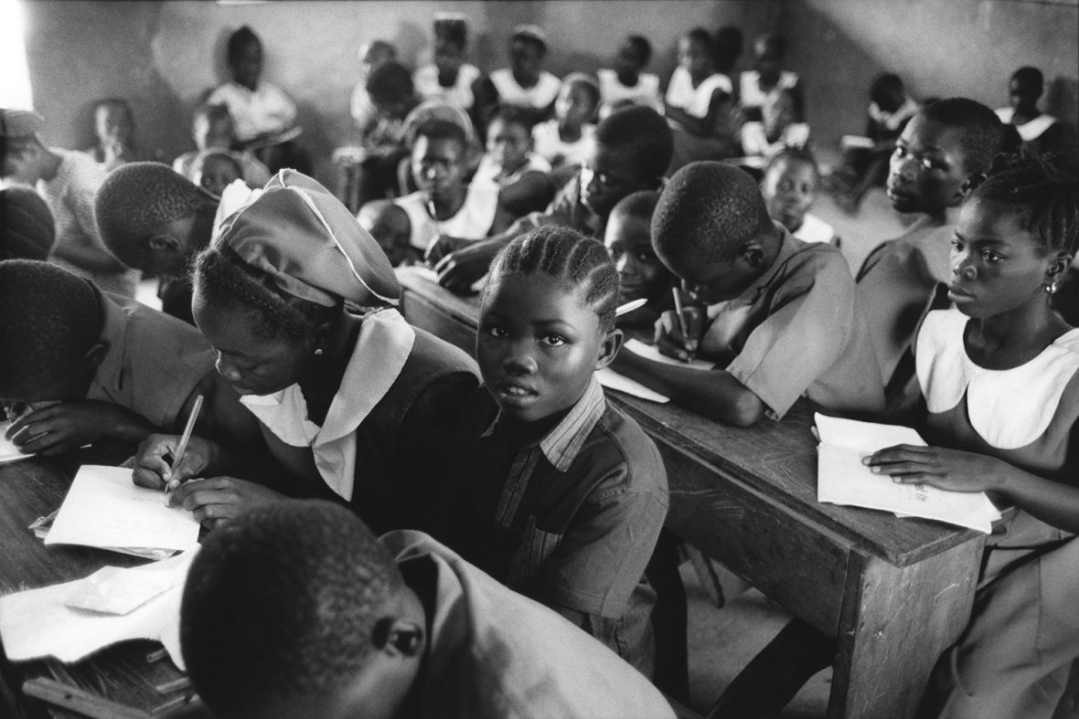 After being separated from her parents during the war, then spending years living in refugee camps in Guinea, Rebecca Fillie, at the centre of this photograph, started school for the first time shortly after the war ended in 2002. She was 10, and was the only child in the classroom without a uniform, but she didn’t let the teasing stop her from attending school, as many other children did