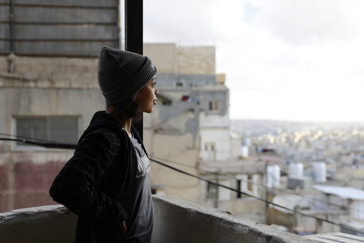 Jordan. UNHCR high profile supporter Liza Koshy pauses to take in the view of Amman as she approaches the home of Umm Muhammad, 39, a refugee from Syria, in Jabal Al-Nuzha, Amman.