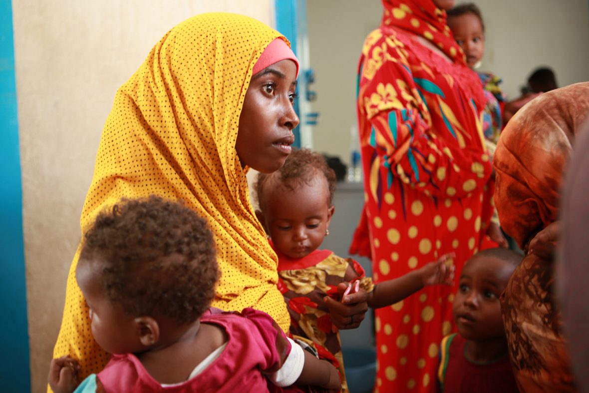 19 year old Maria Abdullahi, who looks after her own child, Nouria, and her cousin’s child, Maysun, both 9 months old, living in a tent in a refugee camp in the desert in Djibouti; they are refugees from Somalia. Maysun’s own mother abandoned her, and Maria took her in, breastfeeding her along with her own daughter.